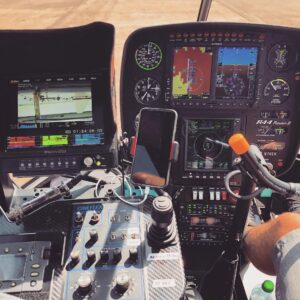 Robinson R44 cockpit with a camera controller and video monitor for aerial filming