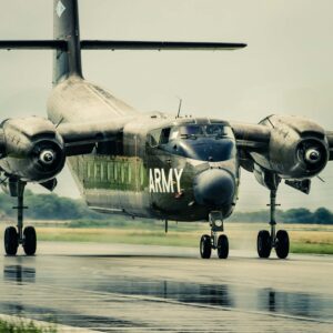 Olive drab U.S. Army Caribou transport taxiing on a wet runway