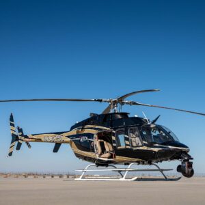 Black Bell helicopter with a camera gimbal parked on the tarmac