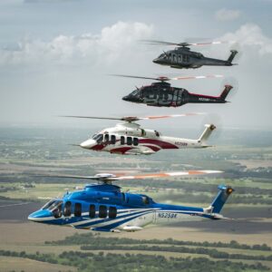 Four Bell 525 helicopters in formation over rural fields