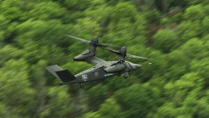 Dark V-280 Valor tiltrotor flying low over dense forest
