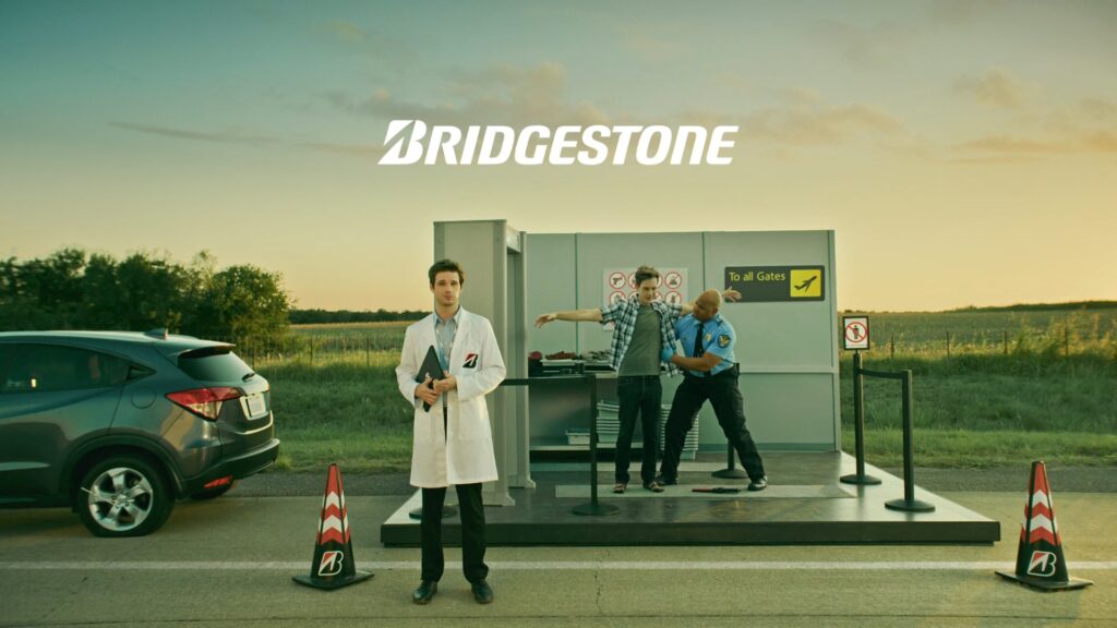 Two technicians beside a car on a Bridgestone commercial set