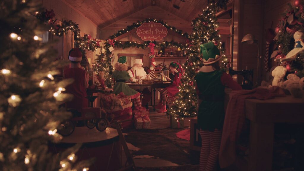 Living room packed with Christmas decorations and a lit tree