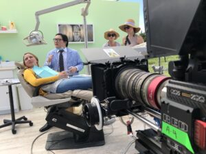 Production crew setting up cameras and lighting on location