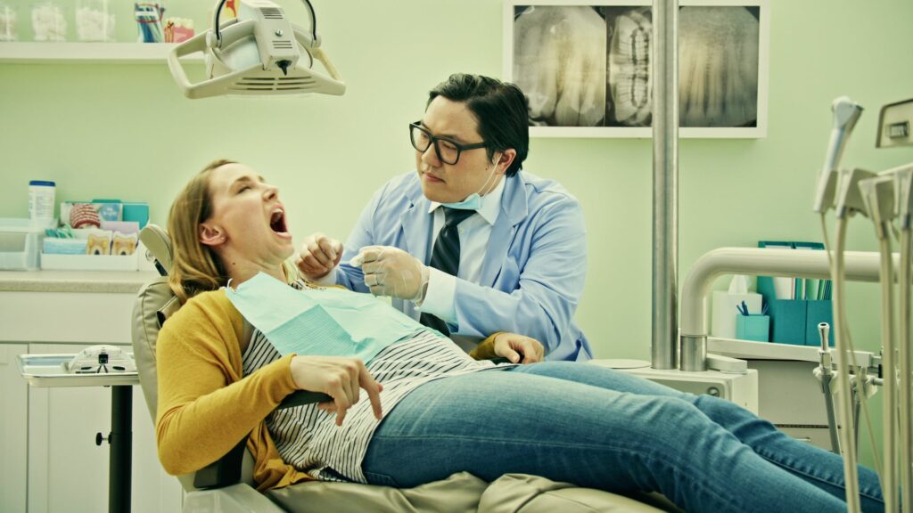 Dentist examining a patient in an exam chair