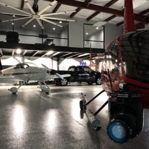 Film lights set up around an aircraft inside a hangar