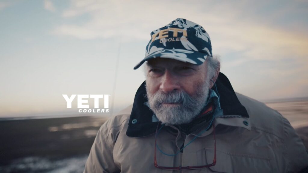 Bearded man in a cap standing on the coast