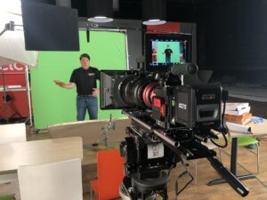 Cinema camera set up in front of a green screen in the studio