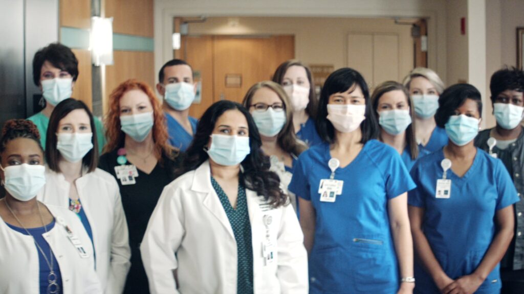 Group portrait of healthcare workers in masks and scrubs