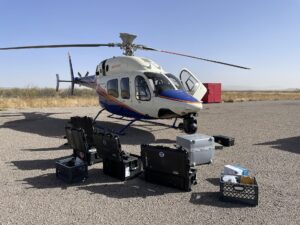 Crew preparing a helicopter for an aerial filming project