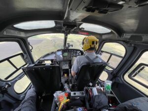 Pilot and camera operator in a helicopter cockpit before an aerial shoot