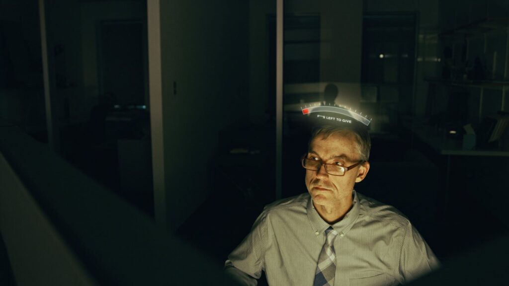 Older woman lit by a single lamp in a dim room at night