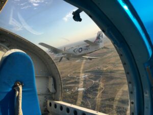 P-51 Mustang seen through a bomber window during air-to-air filming