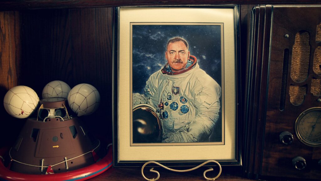 Framed portrait and space memorabilia in a collector's room