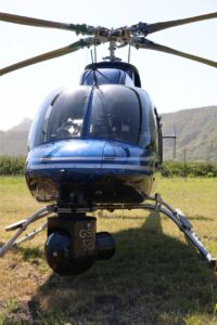 Blue helicopter on grass with a GSS gimbal on the nose